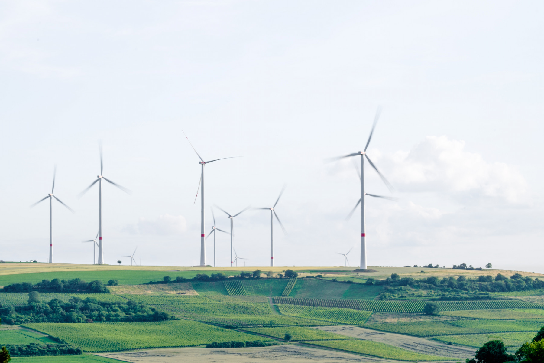 A group of wind turbines in a hilly landscape